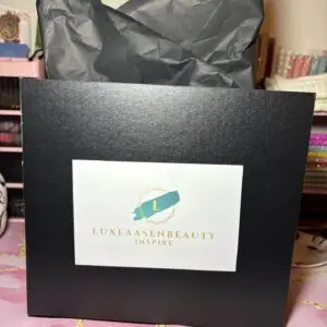 Black gift bag with tissue paper inside.