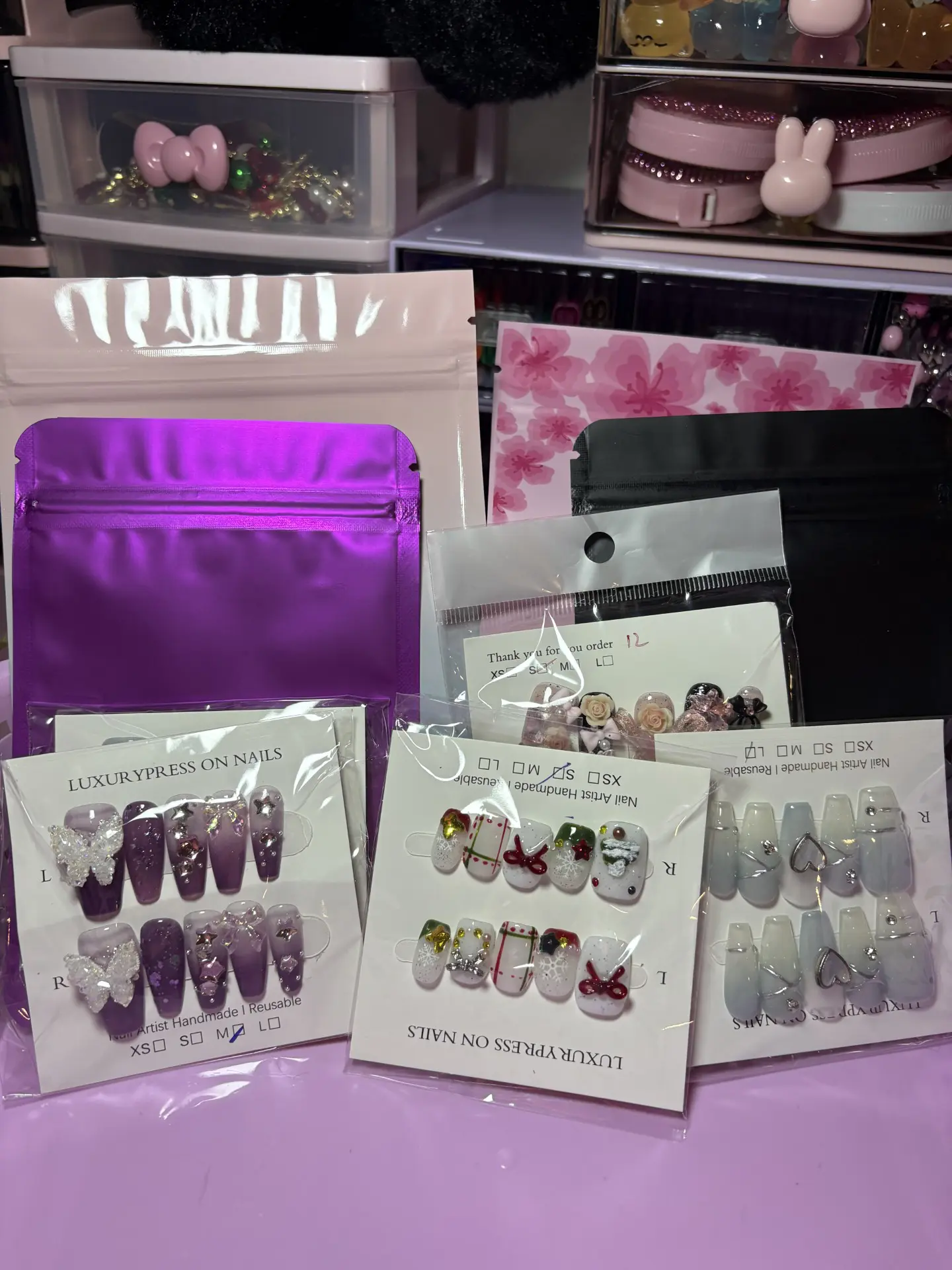 Assorted press-on nails with colorful designs.