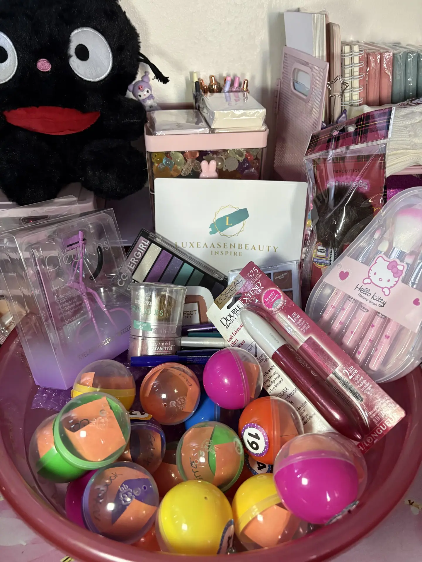 Colorful toys and cosmetics in a bowl.